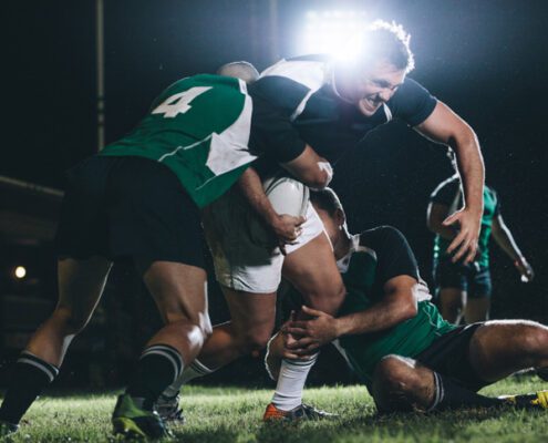 image of men playing rugby by Mullins Treacy Solicitors Waterford